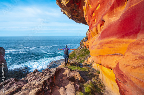 Monte Jaizkibel, Gipuzkoa / Spain »; December 6, 2019: A young man in the red geoforms in Labetxu on Mount Jaizkibel with arms raised photo