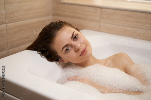 young woman relaxing in bubble bath