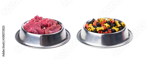 Different dogs food in metal plates isolated on white background. Dog food choice concept