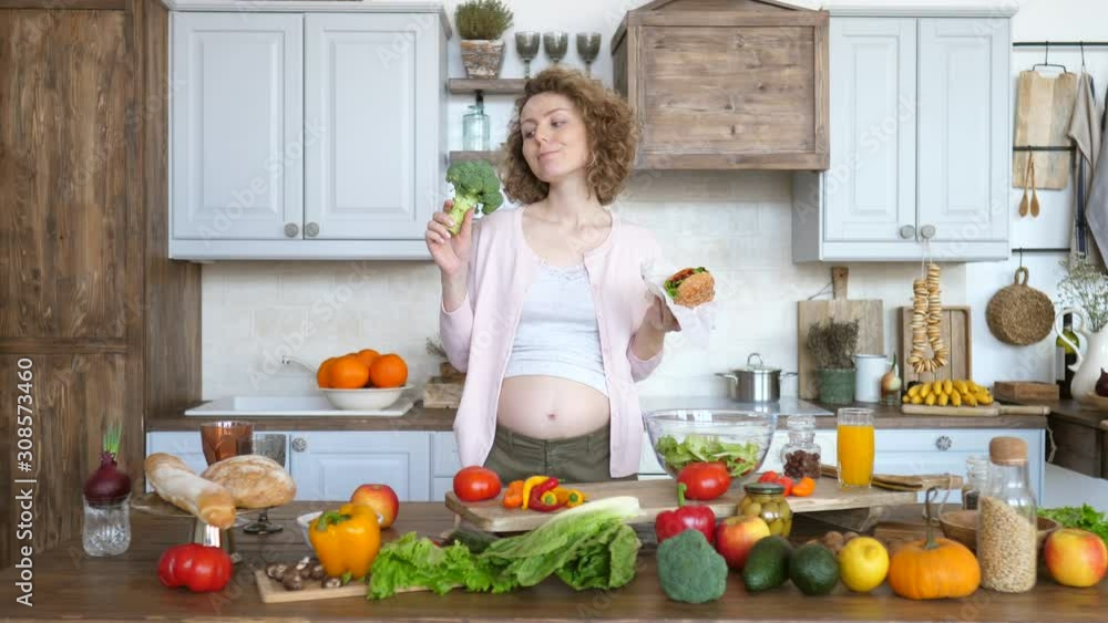 Portrait Of Pregnant Woman With Junk Food And Healthy Food Portrait Of Pregnant Woman With Junk Food And Healthy Food