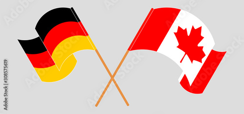 Crossed and waving flags of Canada and Germany
