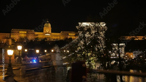 The police motorcade government a lot of cars ride at night over the Szechenyi Chain Bridge Budapest Hungary