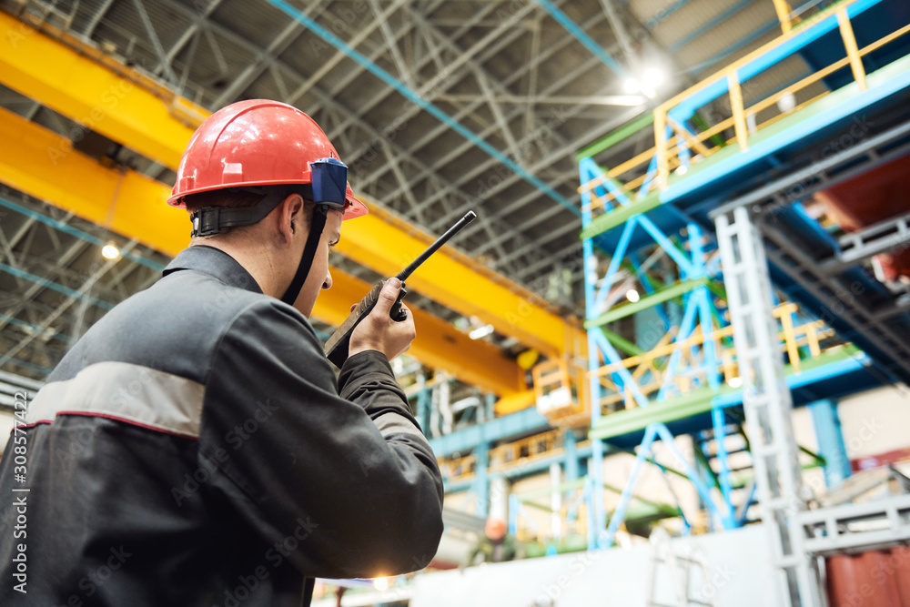 industrial worker on factory with walkie talkie transmitter industrial worker on factory with walkie talkie transmitter