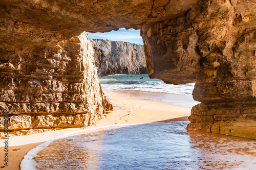 Rock natural cave at the surfers beach Praia do Beliche near Cabo San Vincente, Algarve, Portugal, Europe photo