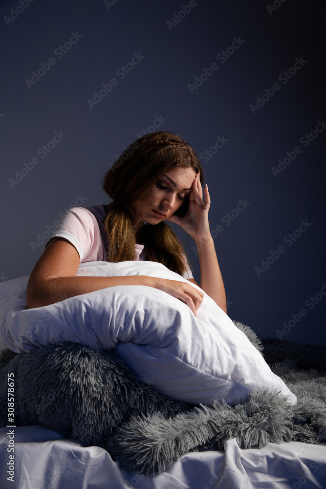 Sad tired female in the bed with pillow want to sleep Sad tired female in the bed with pillow want to sleep