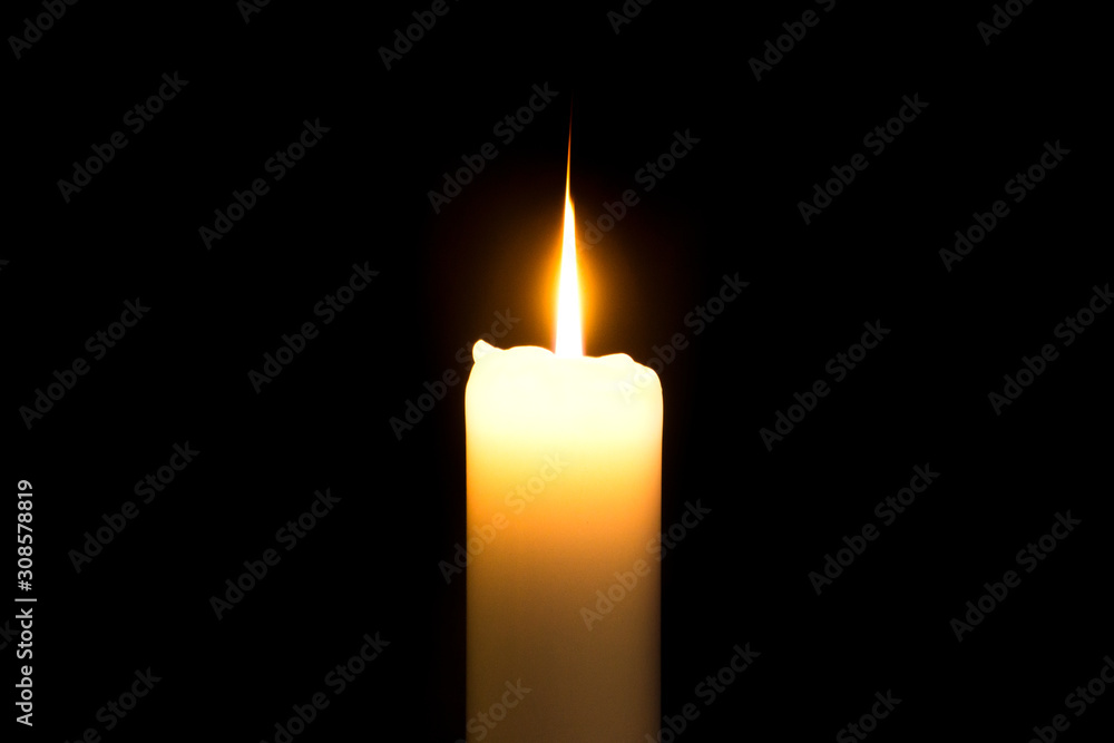 burning candle on a black background. Fire burning candle on a black background. Fire