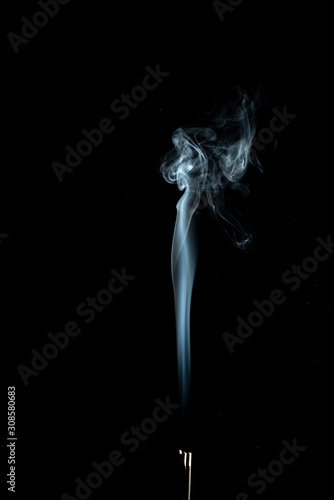 White smoke trailing upwards abstract on a black background