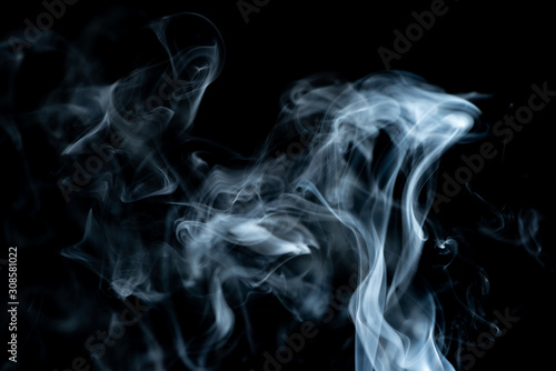 White waves of smoke drifting up abstract on a black background