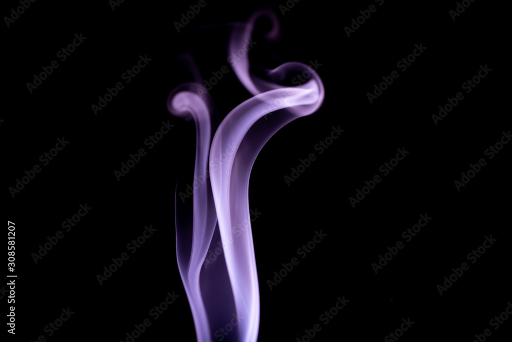 Purple wispy trails of smoke drifting upwards on a black background Purple wispy trails of smoke drifting upwards on a black background