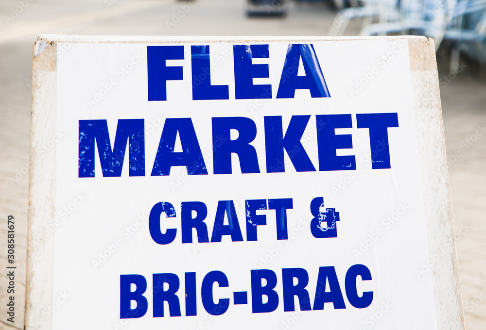 Fototapeta premium Flea Market Craft and Bric--a-brac Collectables Today sign with an arrow point to the right, towards a jumble sale car boot or charity shop sales table in the country side. perfect for resellers