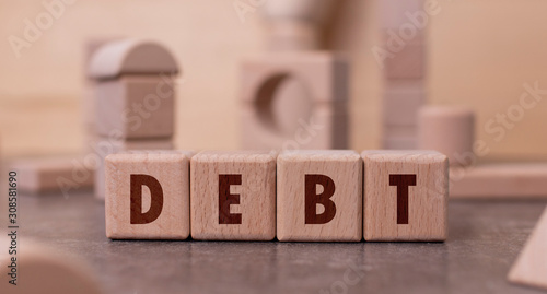 Word "Debt" written with wooden blocks
