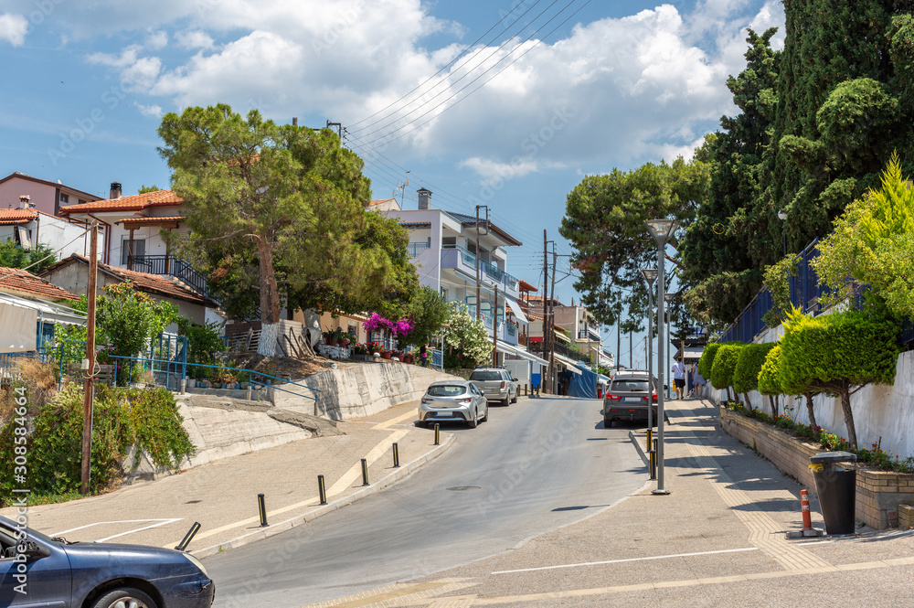Cozy resort town surrounded by greenery and flowers. Greece. Seaside town street