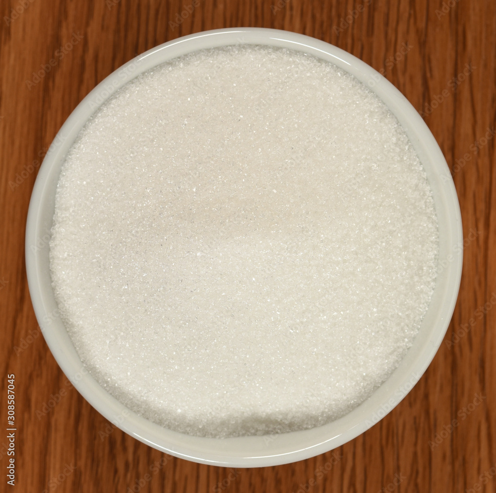 Bowl with sugar on wooden table Bowl with sugar on wooden table