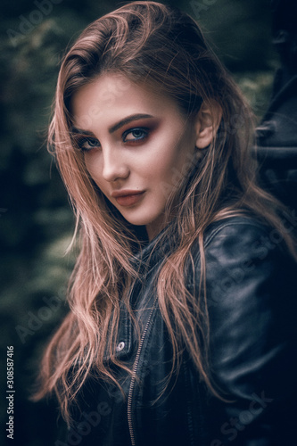 Portrait of a beautiful girl in a black leather jacket