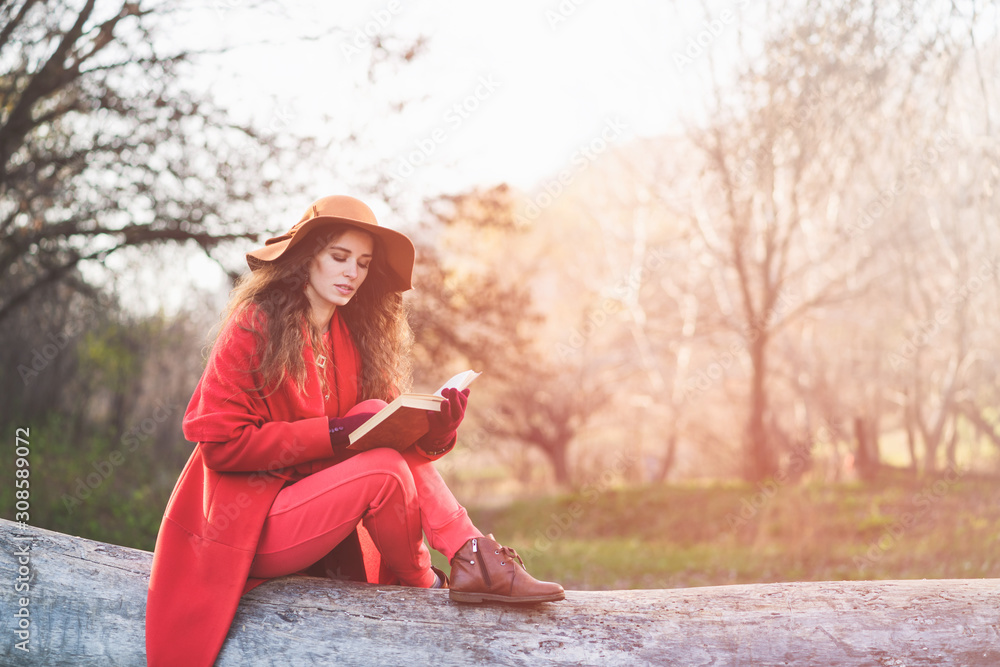 Girl sit on log and read book Girl sit on log and read book