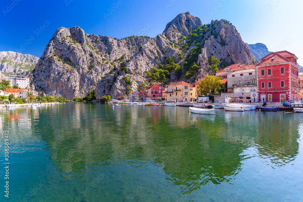 Sunny beautiful view of Cetina river, mountains and Old town in Omis, very popular tourist spot in Croatia