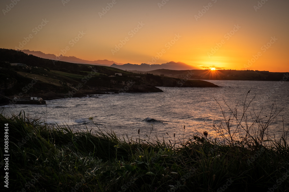 Comillas, Cantabria, northern Spain. Sunset over the ocean.