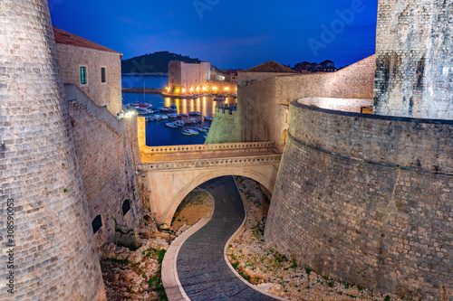 Old city walls and Old Harbour of Dubrovnik at night in Dubrovnik, Croatia