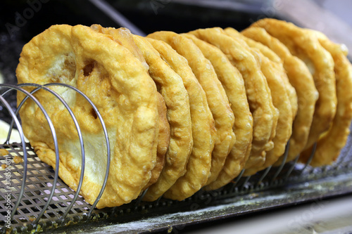 Traditional hungarian food specialty lángos langos langosch for sale on market photo