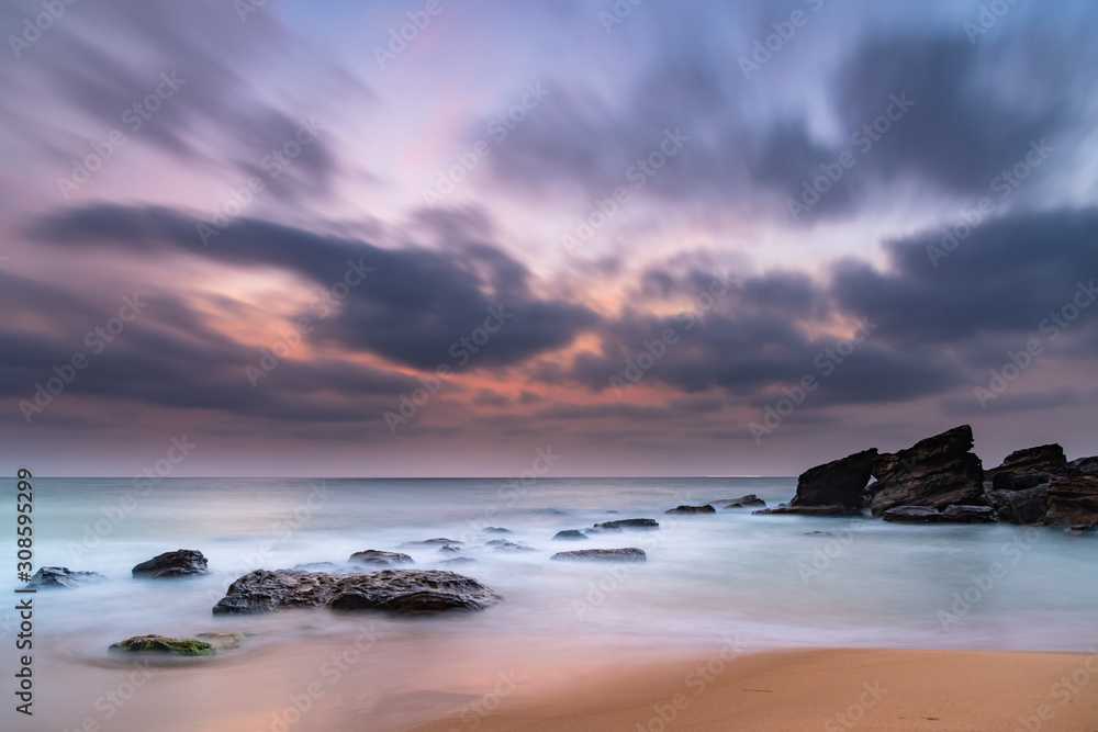 Obraz premium Soft Dawn Seascape with Smoky Haze and Clouds at the Seaside