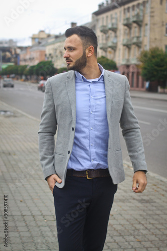 Portrait of a businessman on the street near the road of a European city. A bearded handsome man dressed stylishly. Fashionable guy hipster. Stock photos © snb2087