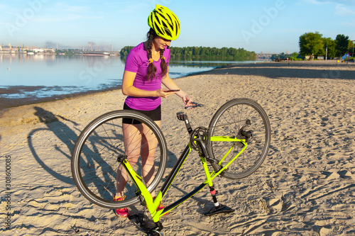 Beautiful athletic girl with a bicycle on the beach