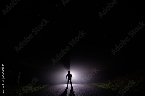 Slika na platnu Silhouette of a man in the darkness
