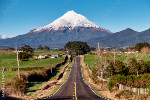 Highway heading directly to the beautiful snow capped volcanic Mount Egmont in Taranaki New Zealand photo