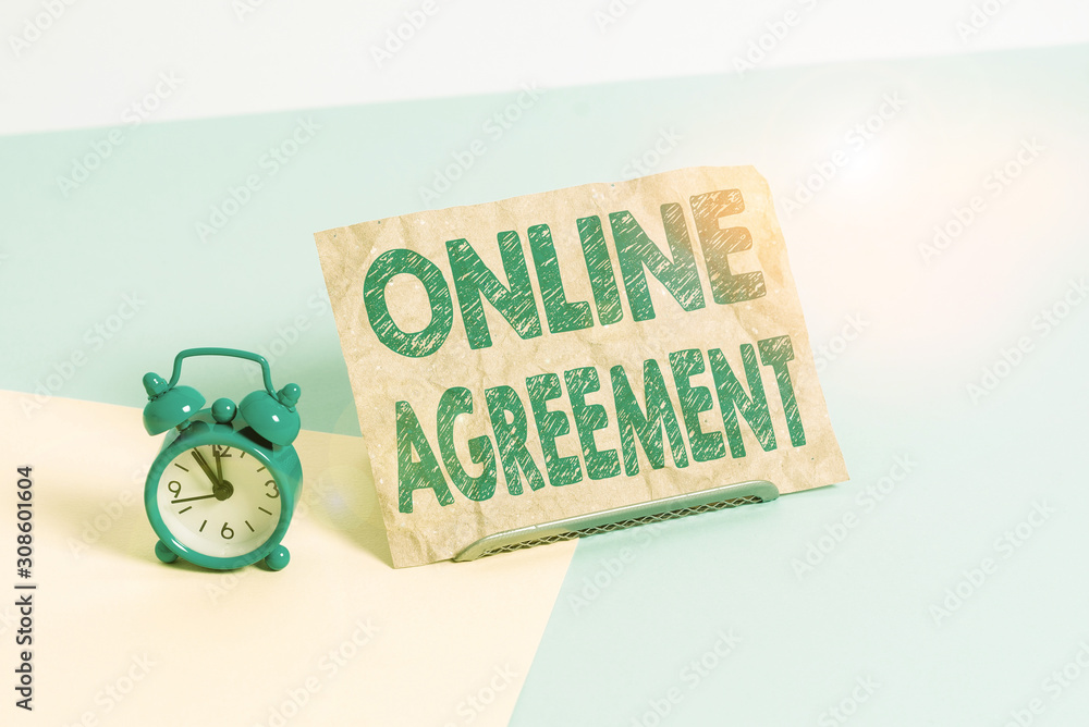 Text sign showing Online Agreement. Business photo text contract modelled signed and executed electronically Mini size alarm clock beside a Paper sheet placed tilted on pastel backdrop Text sign showing Online Agreement. Business photo text contract modelled signed and executed electronically Mini size alarm clock beside a Paper sheet placed tilted on pastel backdrop