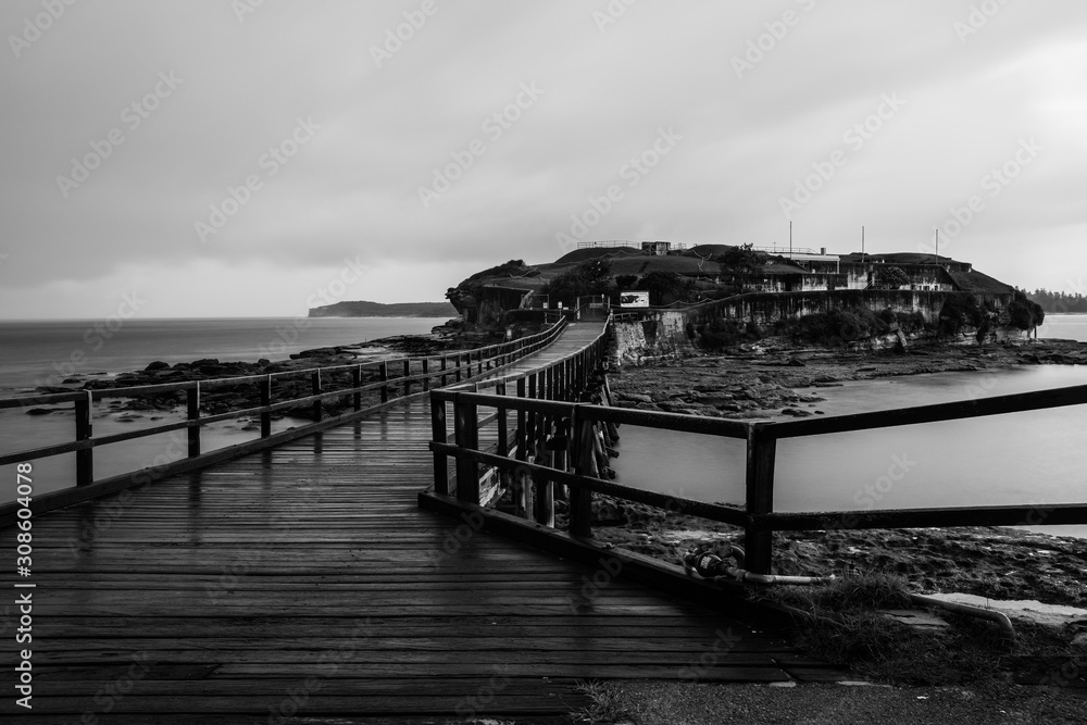 Pedestrian bridge at night leading to small island