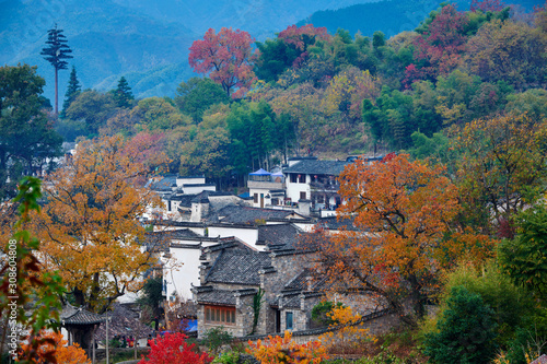 Hui-style architectures in fall forest on the hillside of China. photo