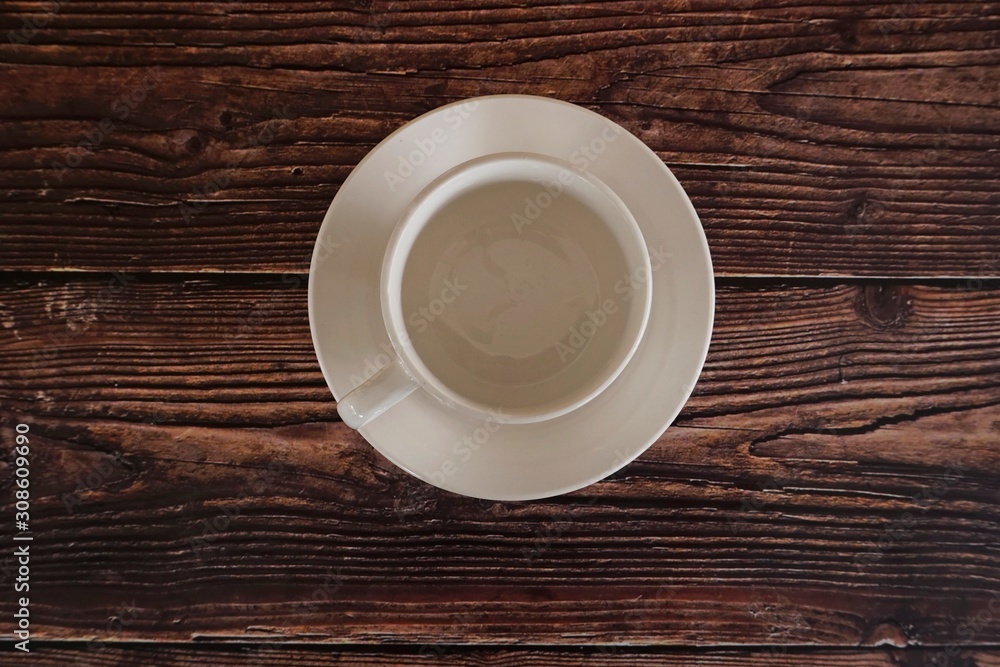a cup on wooden table a cup on wooden table