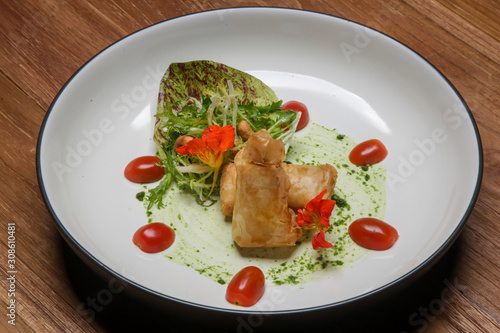 Fried brie in herbal filo pastry served with lettuce and cashew nuts