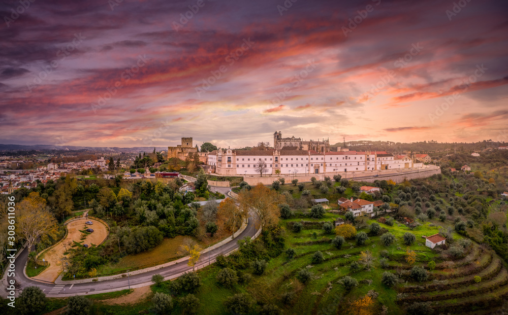 Baroque convent of Christ and the templar castle of Tomar with dramatic colorful sunset sky in Portugal