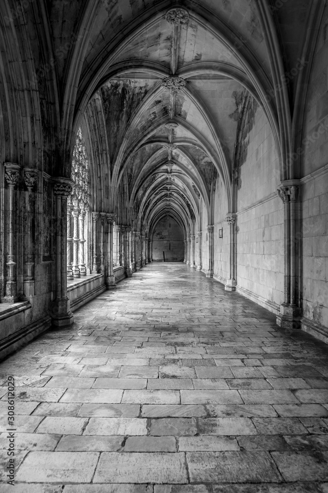 Majestic pointed arches, piers, triforium, clerestory, ribbed vaulting, nave lancet opening in Batalha monastery a masterpiece of Portuguese Gothic architecture