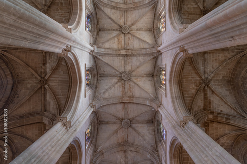 Majestic pointed arches, piers, triforium, clerestory, ribbed vaulting, nave lancet opening in Batalha monastery a masterpiece of Portuguese Gothic architecture