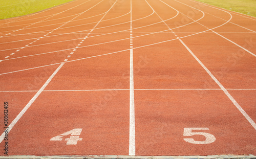 The number at start point of running track or athlete track in stadium. Running track is a rubberized artificial running surface for track and field athletics. © boyloso