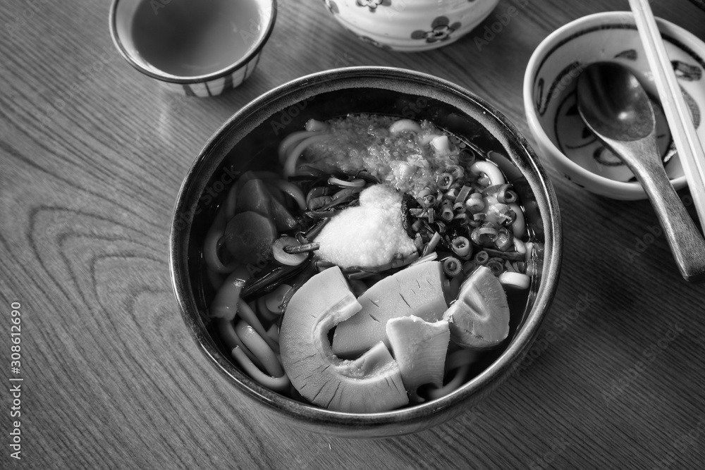 Winter udon with hot tea on wood table. Winter udon with hot tea on wood table.