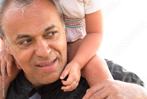 man carrying  child on his shoulders, parental connection