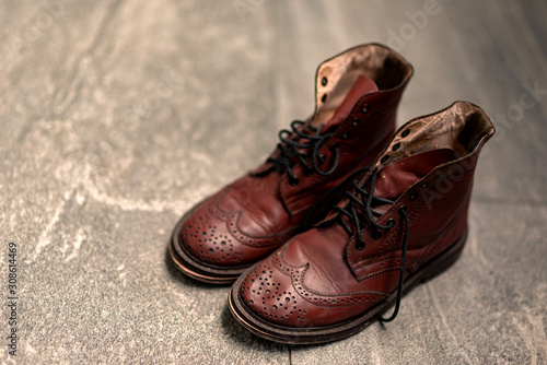 Bilde på lerret Horizontal shot of brown combat boots standing on surface