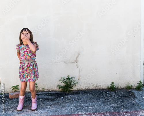 Young girl laughing and looking up with copy space, downtown Mckinney tx