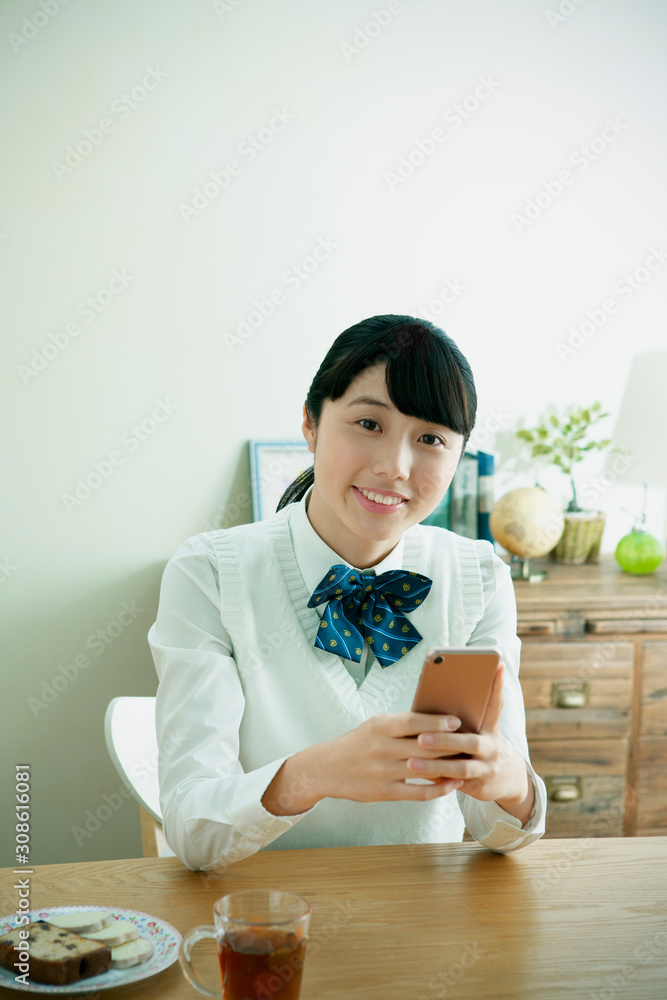 スマートフォンを持った女子学生