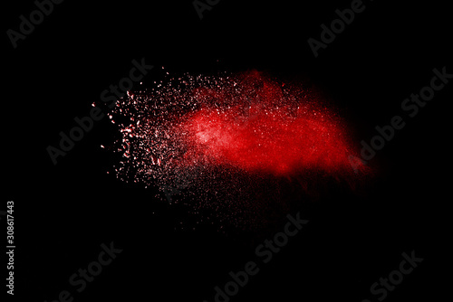 Red powder explosion on black background. Paint Holi.