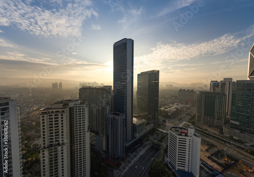 kuala lumpur with large tower building silhouette with dramatic sunrise
