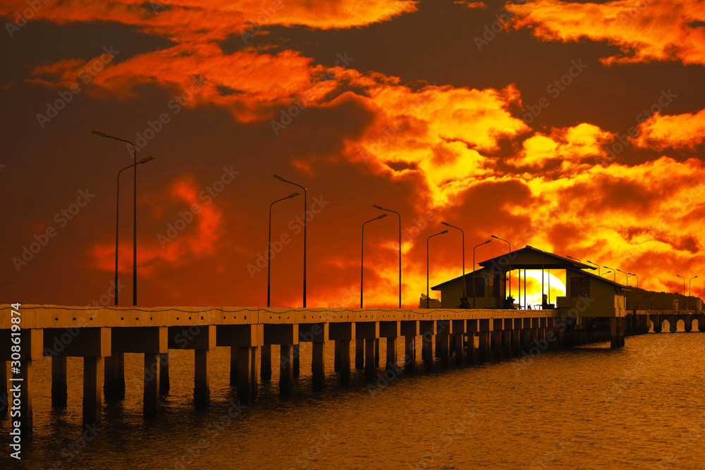 Obraz premium sunset sky red cloud on pavilion on pier and silhouette light poles