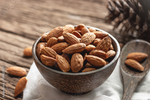 Bake almonds in a wooden bowl.