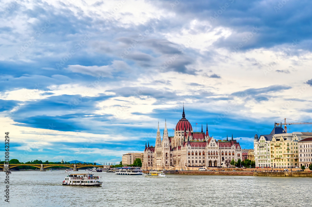 Naklejka premium The Hungarian Parliament Building located on the Danube River in Budapest Hungary at sunset.