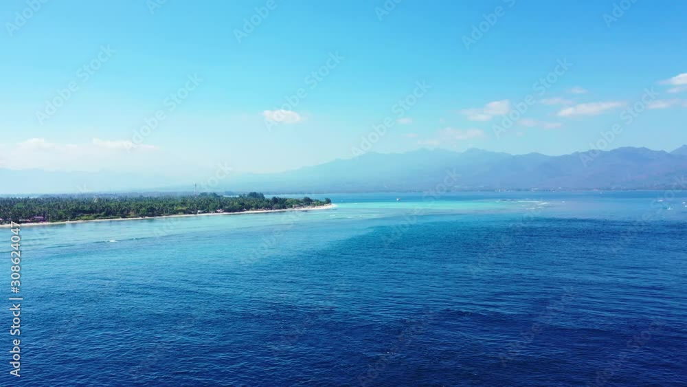A Beautiful Scenery in Indonesia With Glorious Trees and Blue Calm Ocean - Aerial Shot A Beautiful Scenery in Indonesia With Glorious Trees and Blue Calm Ocean - Aerial Shot