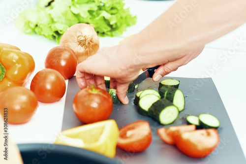 woman cutting vegetables on board