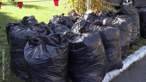 Large group of black garbage bags with different types of waste and trash. The concept of environmental care. 4k footage.